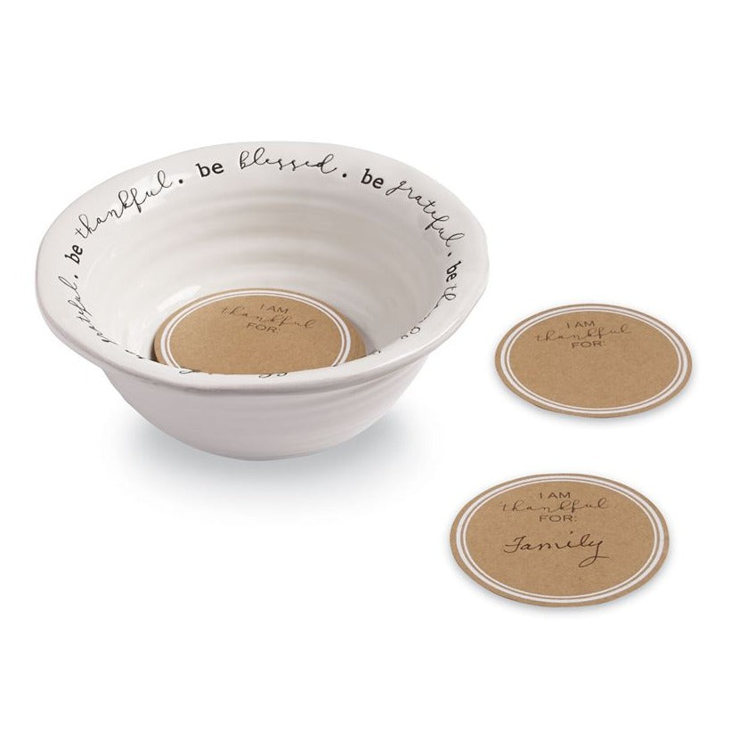 The perfect Thanksgiving tradition! Ceramic bowl features white glazed finish with distressed detail and resist "thankful" sentiments around inner rim. Arrives gift boxed with 25 personalizable kraft cards. Pass and fill this keepsake to share the year's blessings with the whole family.   bowl 3 1/4" x 7 1/2" dia | card 3 1/2" dia