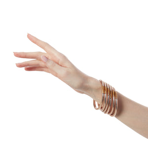 The BuDhaGirl Champagne All Weather Bangles® are here!!! Six orbs filled with divine gold leaf custom blended exclusively for BuDhaGirl. These Champagne AWB® have the same amazing qualities that have made them become the modern woman's go-to jewelry of choice... Set of 6 bangles.