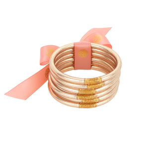The BuDhaGirl Champagne All Weather Bangles® are here!!! Six orbs filled with divine gold leaf custom blended exclusively for BuDhaGirl. These Champagne AWB® have the same amazing qualities that have made them become the modern woman's go-to jewelry of choice... Set of 6 bangles.