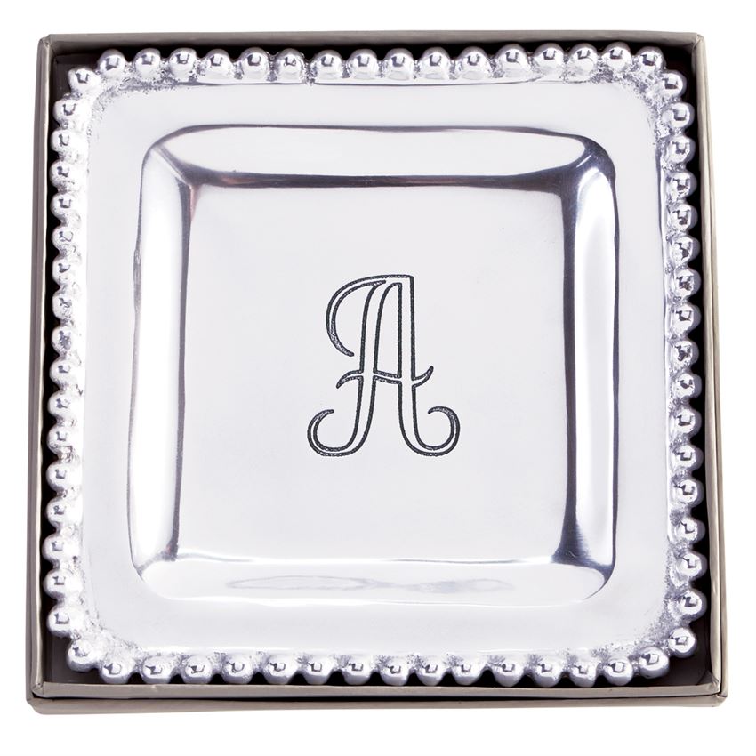 The possibilities are endless! This perfectly giftable trinket tray has multiple uses. Style it as a true bedside or vanity trinket tray, place it in your entryway as your catchall, or use it to entertain as a cocktail napkin holder. This high-polished cast aluminum trinket dish features dimensional beaded edge and engraved center initial. Perfectly giftable in elegant paper wrapped gift box.  Dimensions: 7" x 7"